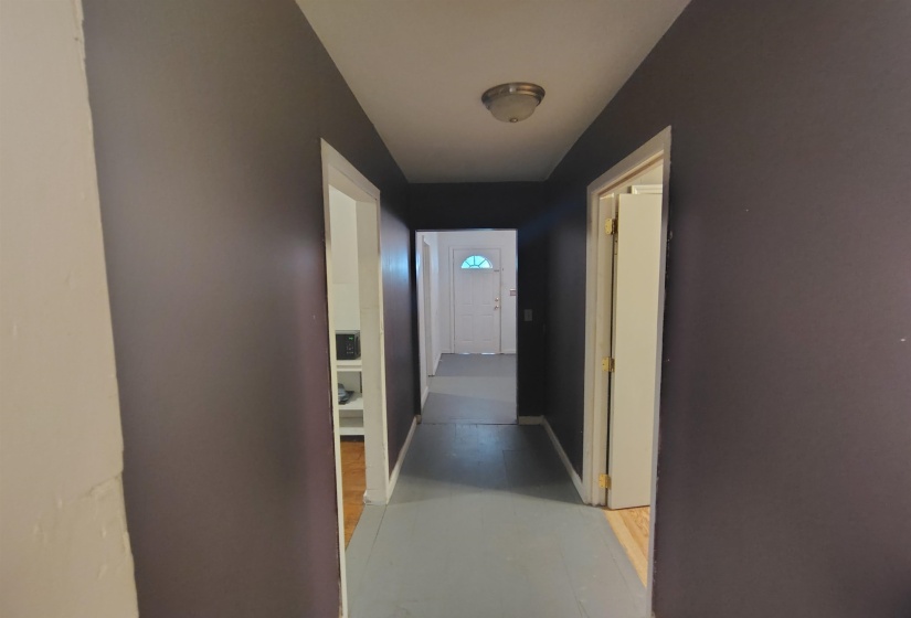 Hallway featuring dark painted walls and a flush-mount ceiling light