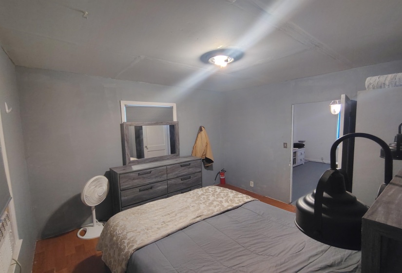 Room with wood-finish flooring, gray walls, and a semi-flush mount ceiling light