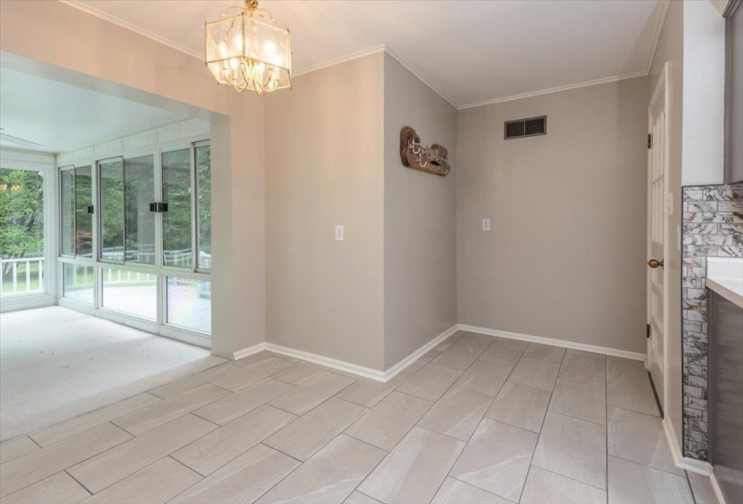 Light grey tile flooring with a decorative chandelier