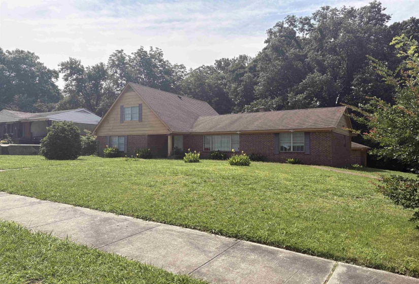 Brick and siding exterior residence with an expansive front lawn
