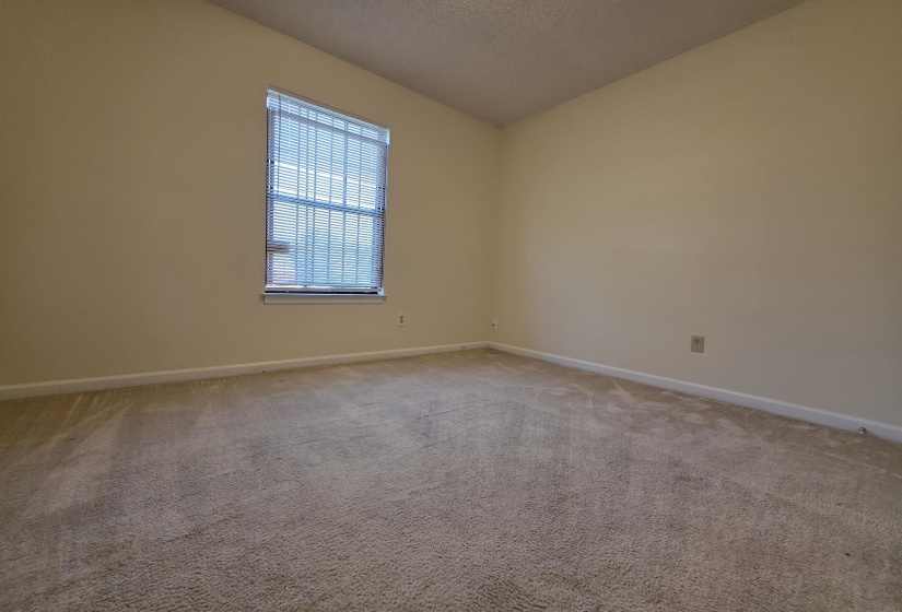 Neutral-toned wall paint with a window featuring horizontal blinds