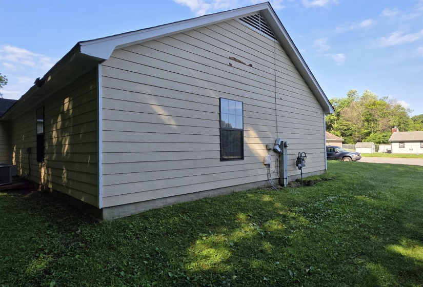 Exterior siding with a window and visible utility meters