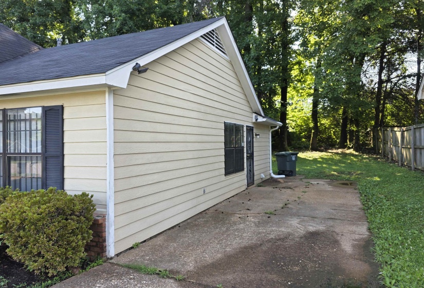 Light beige horizontal siding exterior with a dark shingle roof