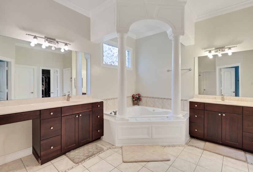Soaking tub with architectural column detailing and surrounding ceramic tile