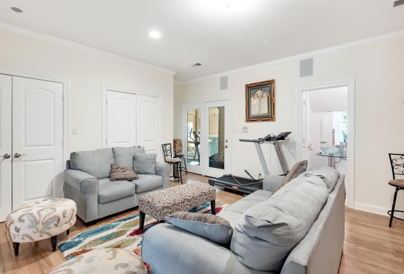Spacious interior featuring light wood-finish flooring, recessed lighting, and white crown molding