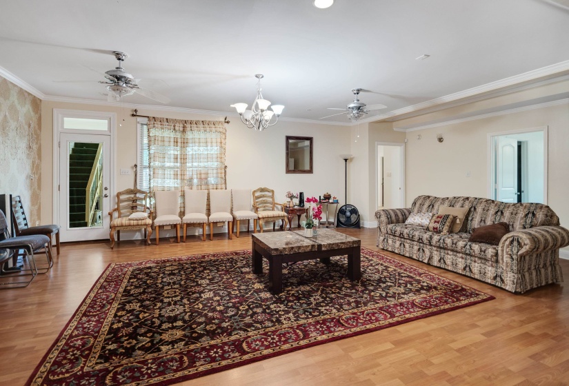 Spacious common area featuring light wood-finish flooring, recessed lighting, and crown molding