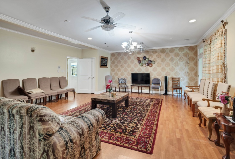 Spacious interior with wood-finish flooring and crown molding