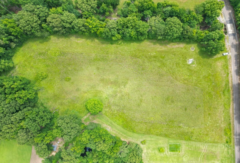 Nestled among mature trees, this property offers a rare combination of open land and natural privacy in a desirable rural setting.