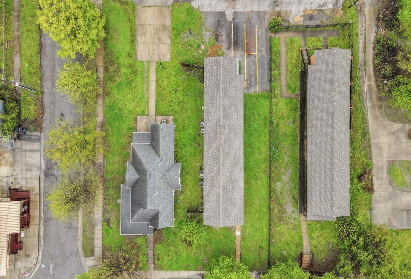 Three distinct properties featuring gabled and pitched roofs, surrounded by concrete driveways and walkways