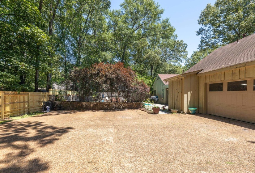 Rear entry garage with large parking area outside the garage