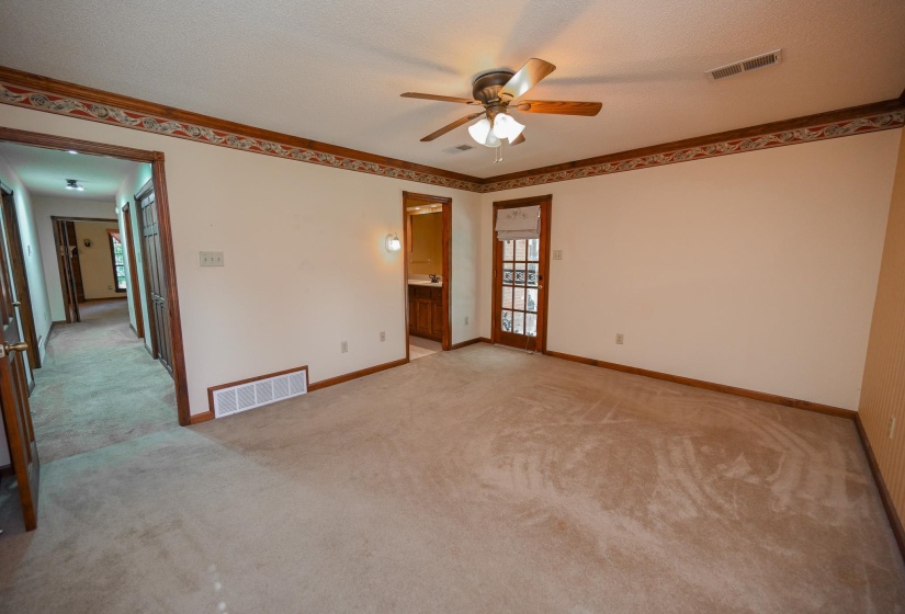 Primary has spacious walk-in closet and door leading to back covered patio and private primary bathroom.