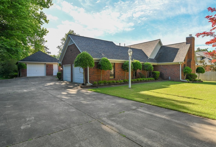 Brick exterior and vinyl home with two-car garage and an additional detached 1 1/2 garage/shop.