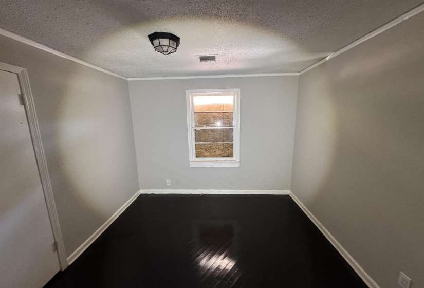 Room featuring light gray walls, dark wood-finish flooring, and white trim