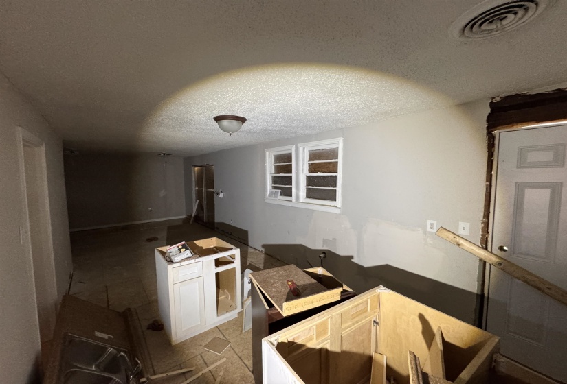 Interior space featuring a flush mount ceiling light, dual pane windows, and a ceiling-mounted air vent