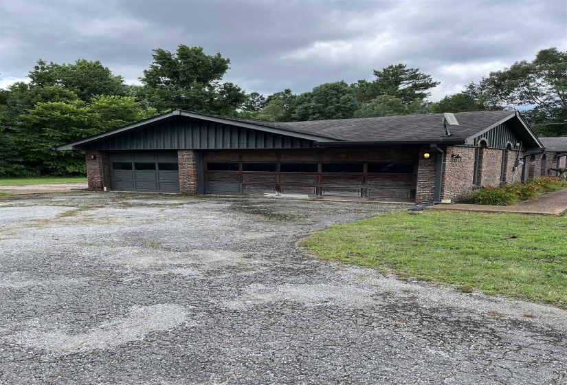 Brick exterior featuring a multi-car garage with two distinct door styles