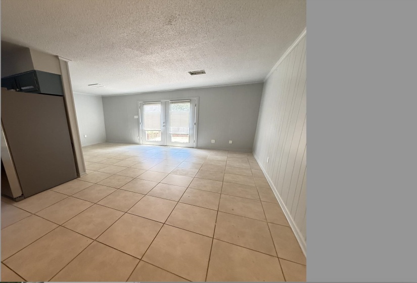 Light-toned ceramic tile flooring extending throughout the space