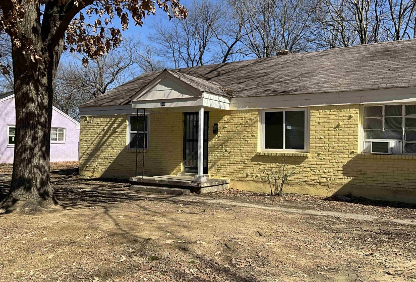 View of front of property with brick siding and cooling unit