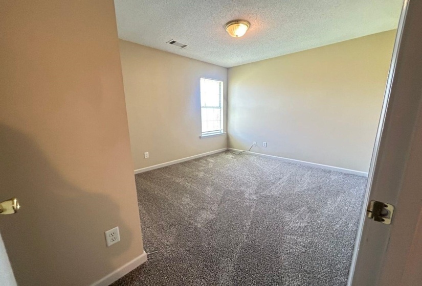 Unfurnished room with carpet flooring and a textured ceiling