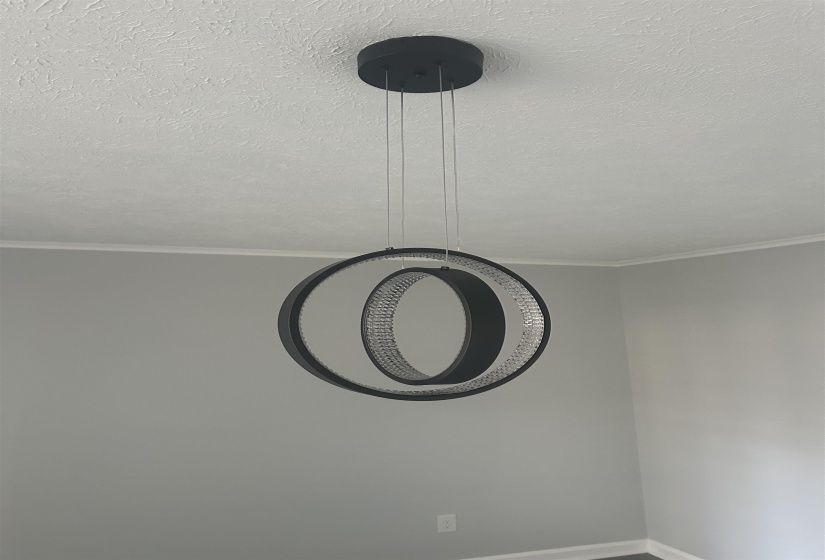 Detailed view of crown molding and a textured ceiling