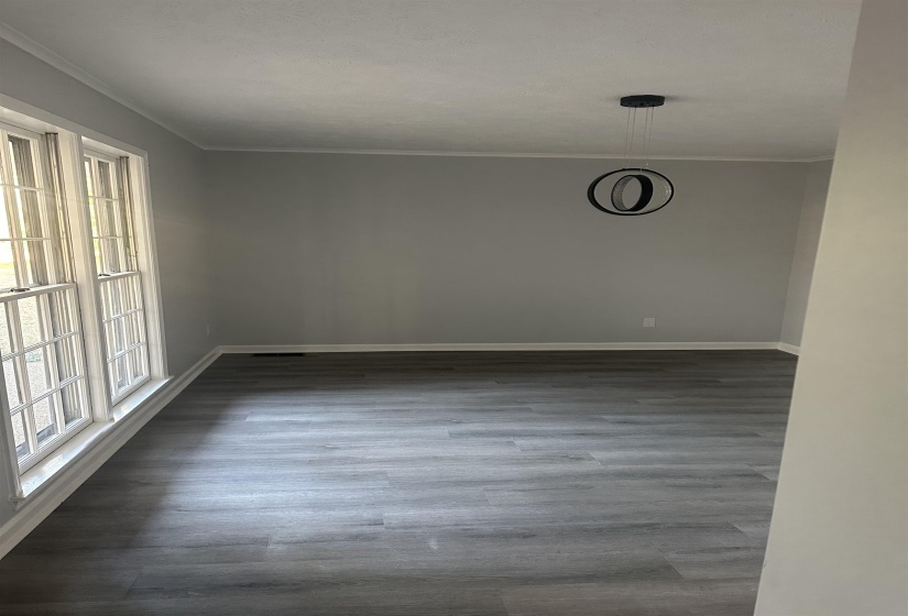 Unfurnished room with dark wood finished floors and ornamental molding