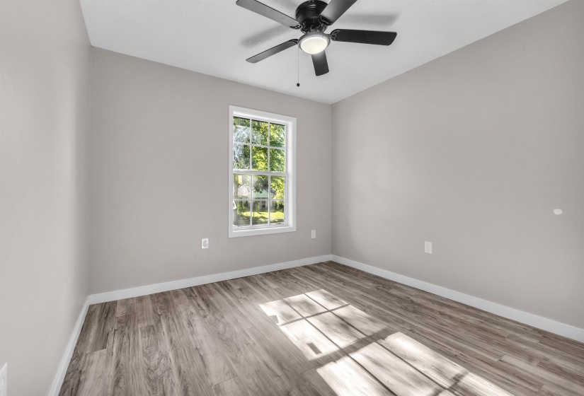 Spare room featuring light wood-style floors and ceiling fan