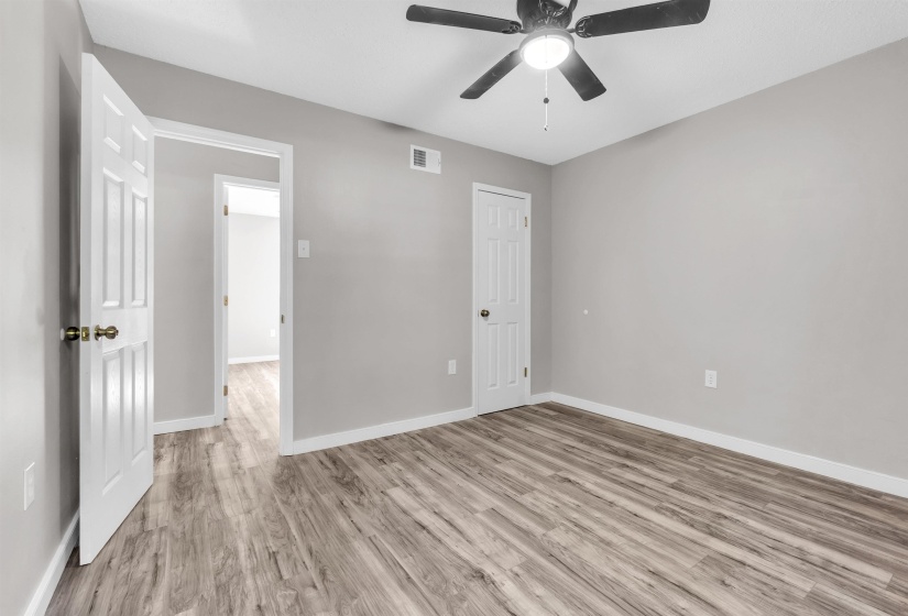 Unfurnished bedroom with light wood finished floors and a ceiling fan