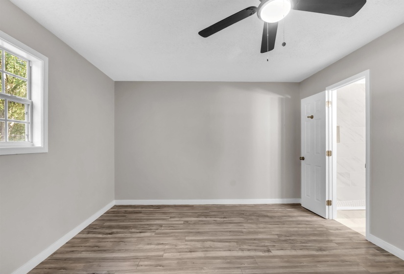 Spare room with light wood-type flooring and ceiling fan