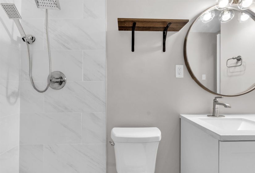 Bathroom featuring vanity and tiled shower