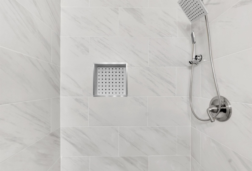 Bathroom view of a tile shower