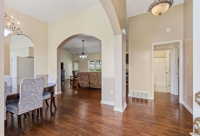 Arched doorways complement the wood-finish flooring