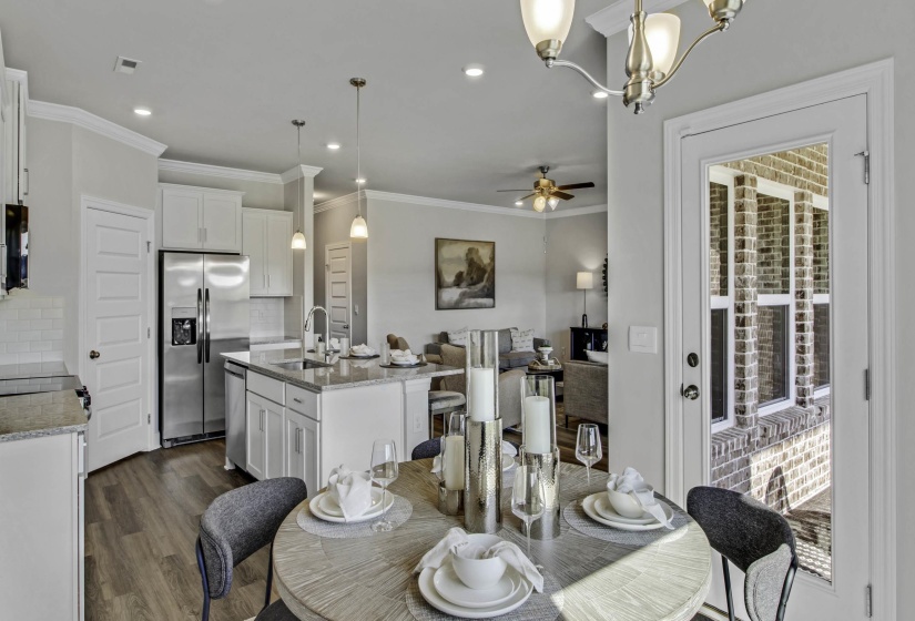 Dining area with dark wood-style floors, a ceiling fan, ornamental molding, and hanging lights