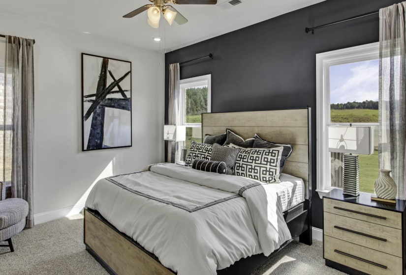 Carpeted bedroom with baseboards and ceiling fan