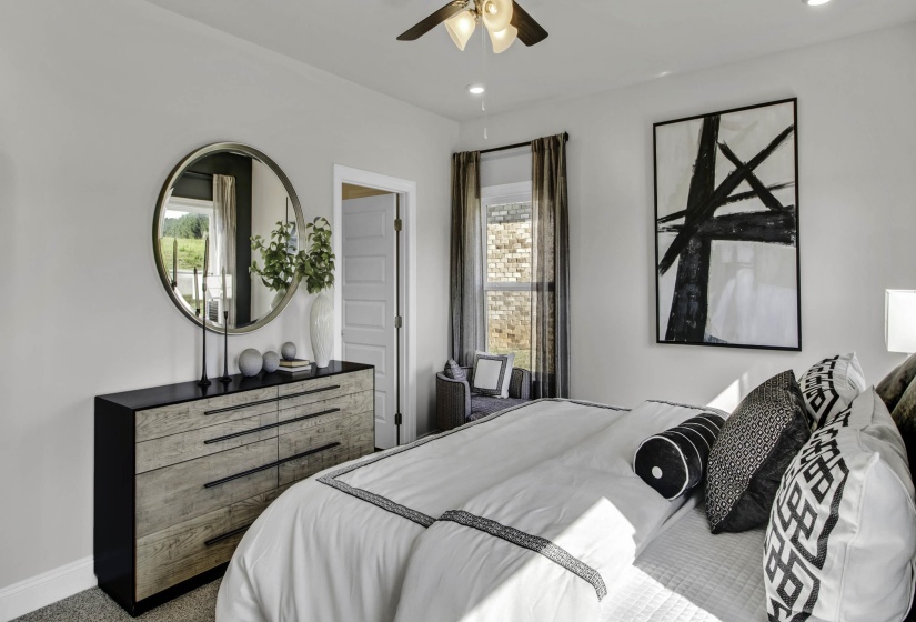 Carpeted bedroom featuring a ceiling fan and recessed lighting