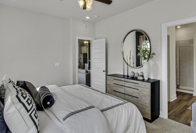 Bedroom featuring recessed lighting, a ceiling fan, stainless steel fridge with ice dispenser, and dark carpet