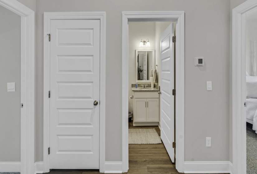 Hallway featuring baseboards and dark wood-type flooring