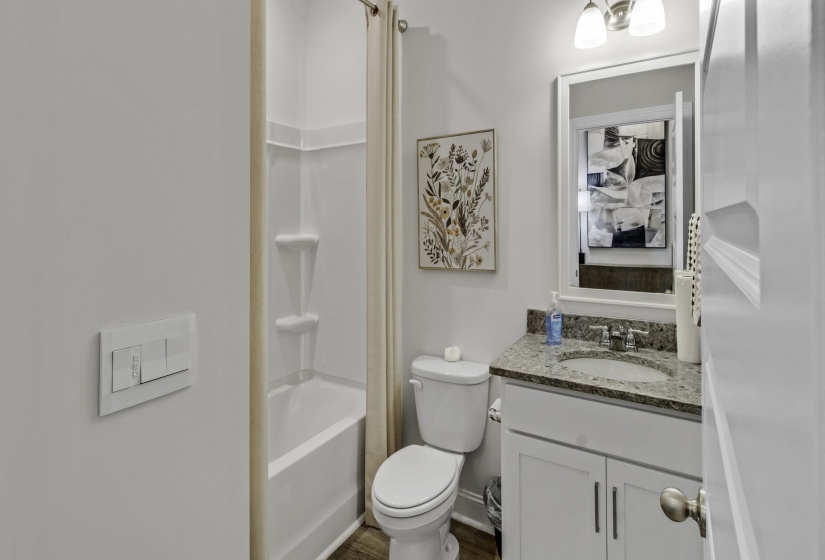 Full bath featuring vanity and bathing tub / shower combination