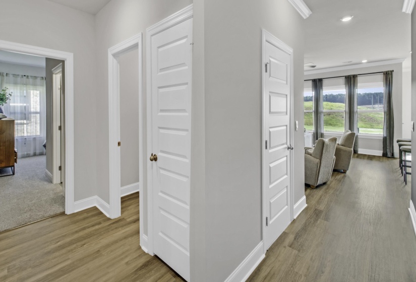 Hallway with plenty of natural light, light wood-style floors, and recessed lighting