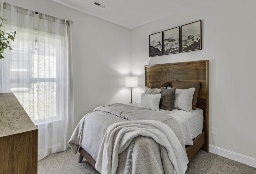 Bedroom featuring light colored carpet and baseboards