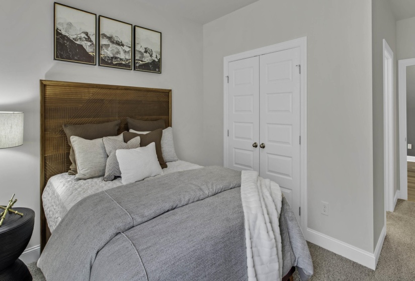 Carpeted bedroom featuring baseboards and a closet