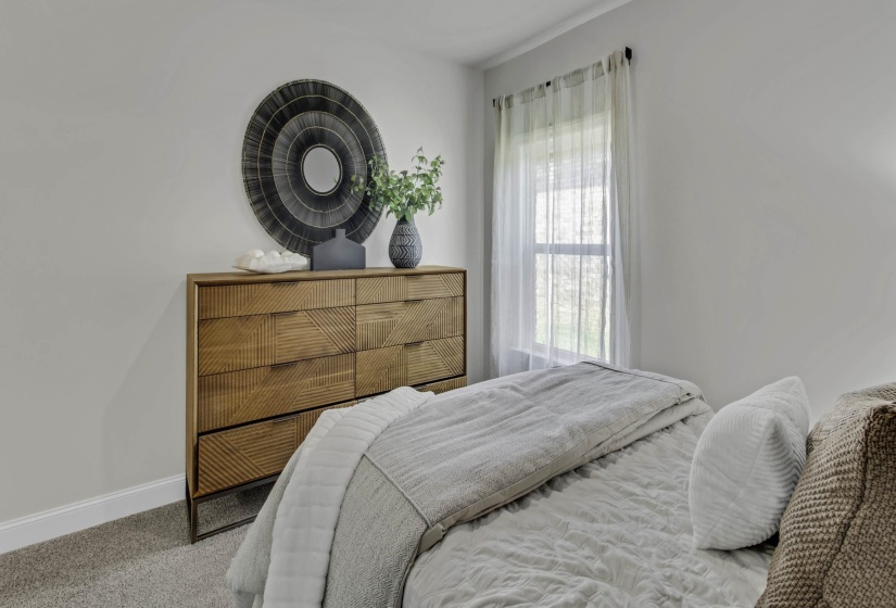 Carpeted bedroom with baseboards