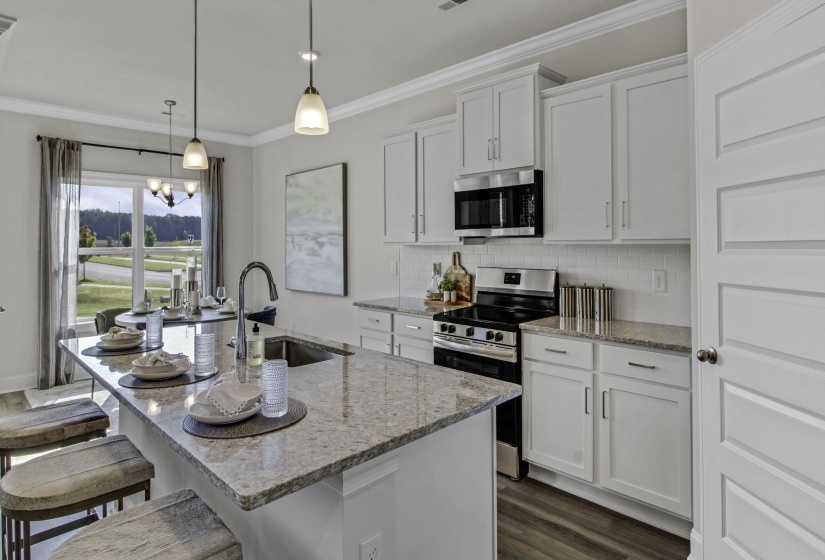 Kitchen featuring stainless steel appliances, white cabinets, dark wood-style floors, backsplash, and ornamental molding