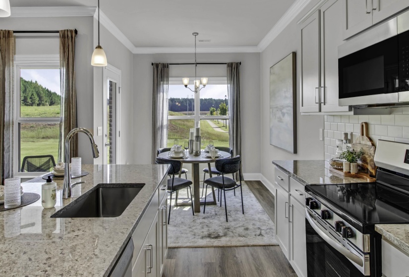 Kitchen featuring stainless steel appliances, dark wood finished floors, crown molding, white cabinets, and light stone countertops