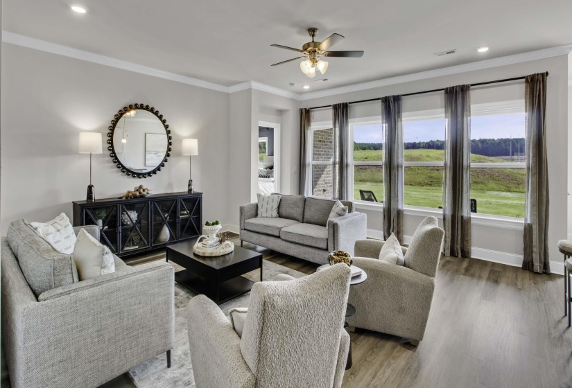Living area with crown molding, recessed lighting, ceiling fan, and wood finished floors