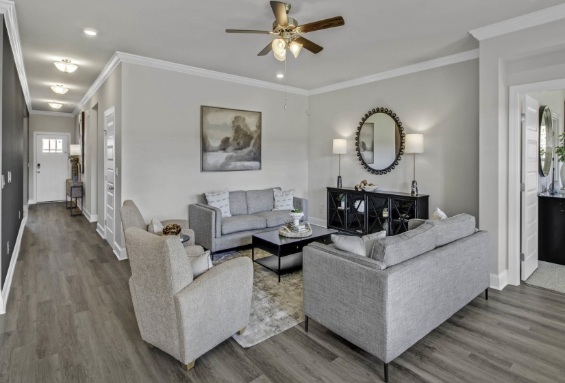 Living room featuring ornamental molding, ceiling fan, wood finished floors, and recessed lighting