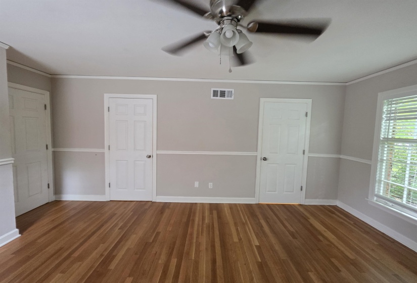 Light wood-finish flooring complements the neutral wall tones