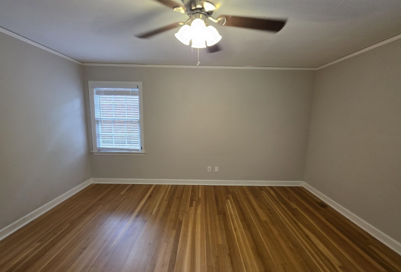 Wood-finish flooring, neutral wall paint, and white trim