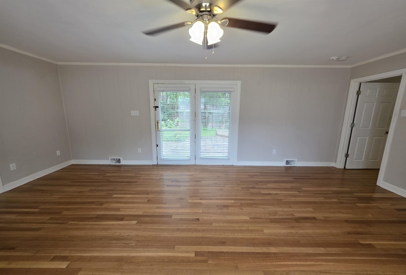 Hardwood flooring throughout, with neutral wall tones and white baseboards