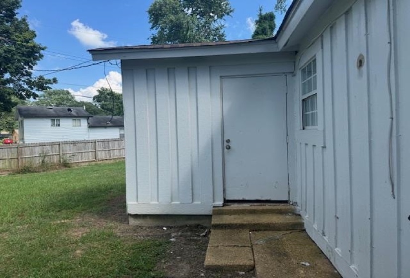 View of exterior entry featuring board and batten siding