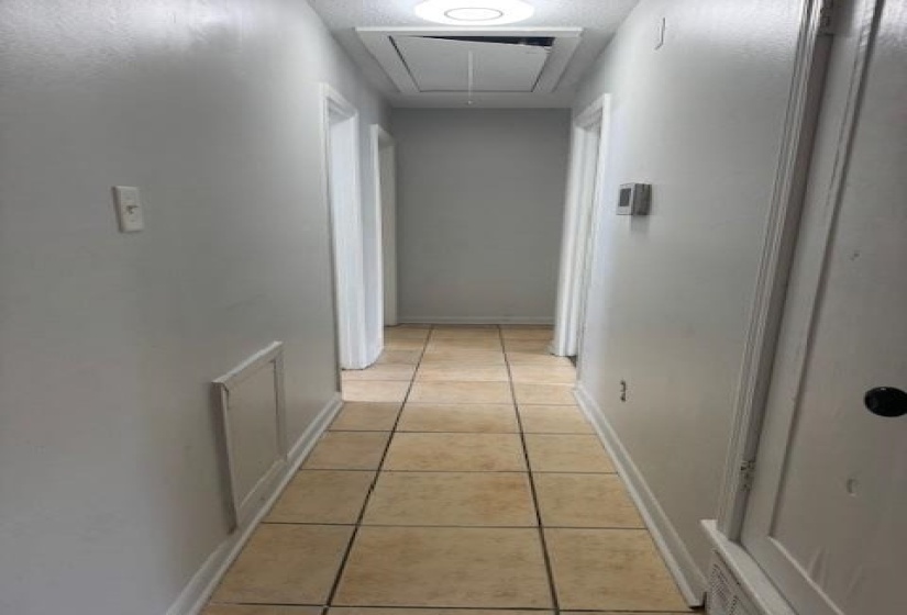 Hallway featuring attic access