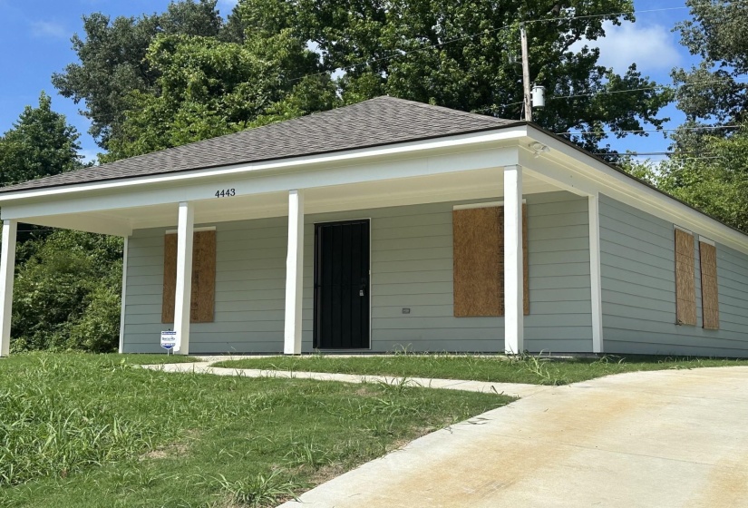 Light blue siding exterior with a covered front porch featuring white support columns and trim
